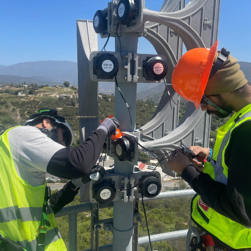 HQE crew installing an intelligent outdoor warning siren